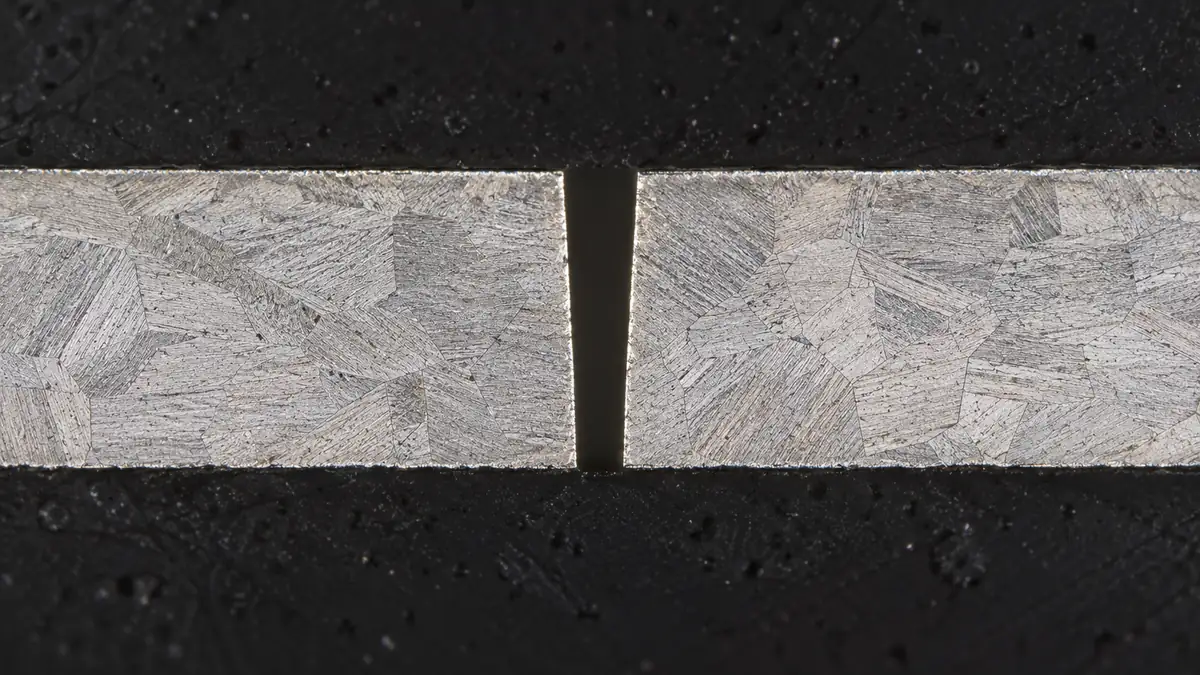 Metallographic cross-section of a precision laser-cut slot with slight wall taper